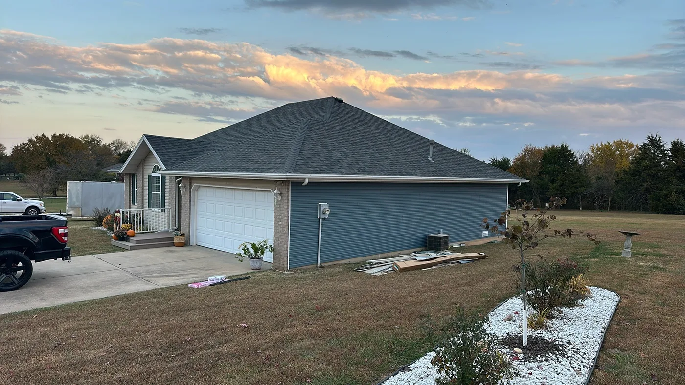 Completed asphalt shingle roof on a Springfield-area home at sunset