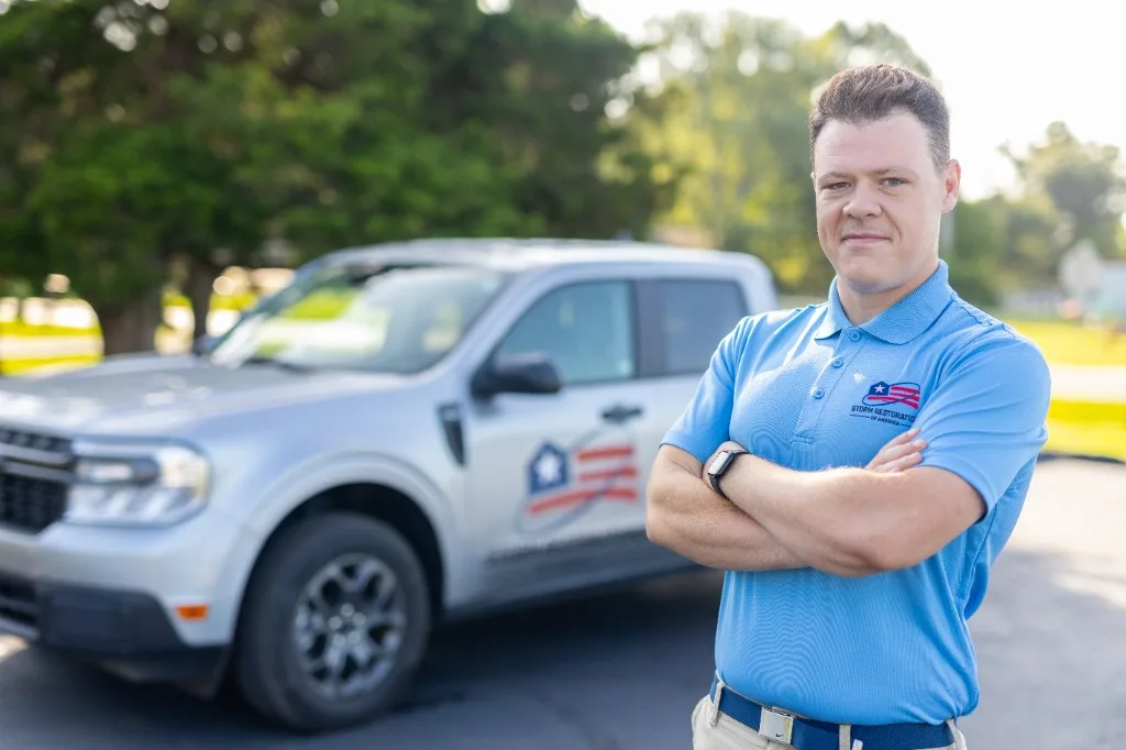 SRA team member standing in front of a branded company truck